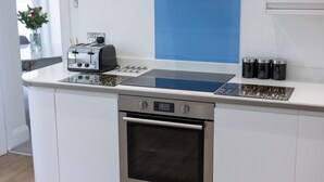 A kitchen with a built-in oven, a toaster, and a coffee maker.