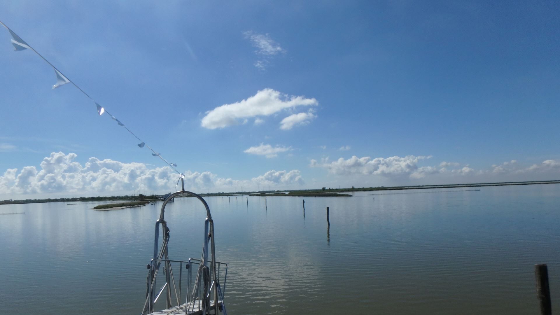A calm lake with a clear sky and a boat dock.