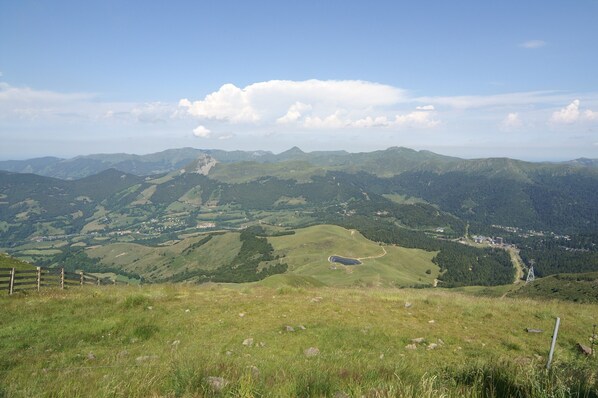 A panoramic view of a mountainous landscape with a clear sky.