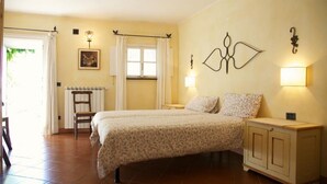 A bedroom with a double bed, a nightstand, a cabinet, a chair, a radiator, and a window with curtains. - Villa With Fantastic Sea Views, Surrounded By Vineyards CITRA  009022-LT-0083 (Celle Ligure)