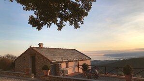 A small stone building with a sloped roof, surrounded by gravel and potted plants. - Villa With Fantastic Sea Views, Surrounded By Vineyards CITRA  009022-LT-0083 (Celle Ligure)