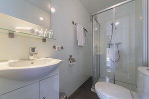 Shower, hair dryer, towels, shampoo