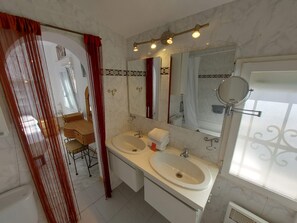 Combined shower/tub, hair dryer, towels, toilet paper