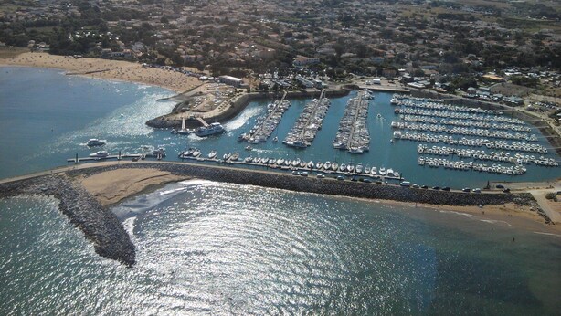 An aerial view of a coastal marina with numerous boats docked, a sandy beach, and a residential area in the background. - Au Calme Stone house, large pool. near sea1,.5 km classified 4 stars (Saint-Pierre-D'oléron)
