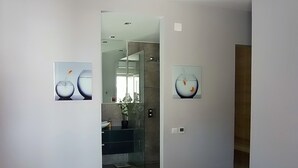 A modern bathroom with a glass shower enclosure, a sink, and a mirror. - Splendid Apartment right next to a sandy beach (Split)