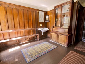 A wooden-paneled room with a bench, a sink, and a cabinet. - Lagafater Lodge (Stranraer)