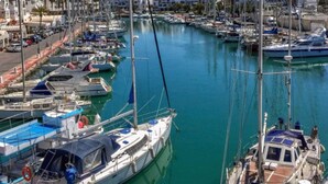 A marina with multiple boats docked, a clear blue sky, and buildings in the background. - Luxery apartment "SEAGULL" - Family friendly - 2 bedrooms (max.4 pers.) (El Ejido)