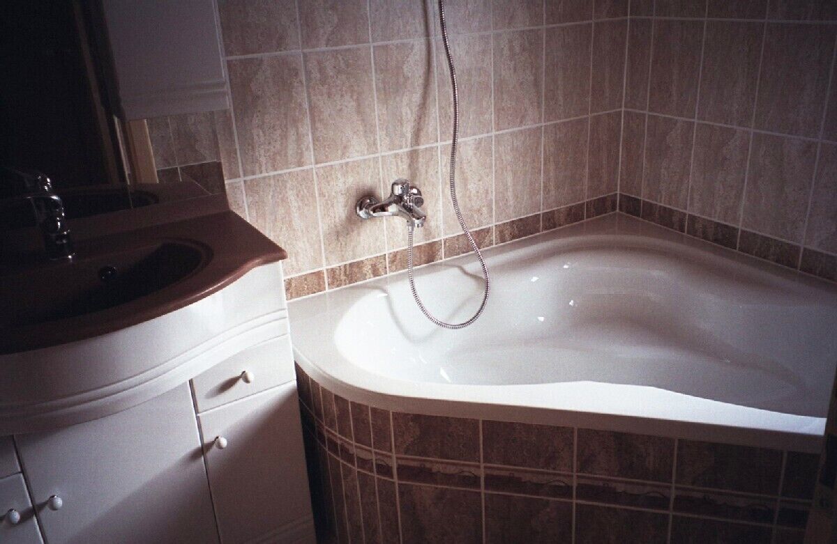 A bathroom with a bathtub, a sink, and a shower.
