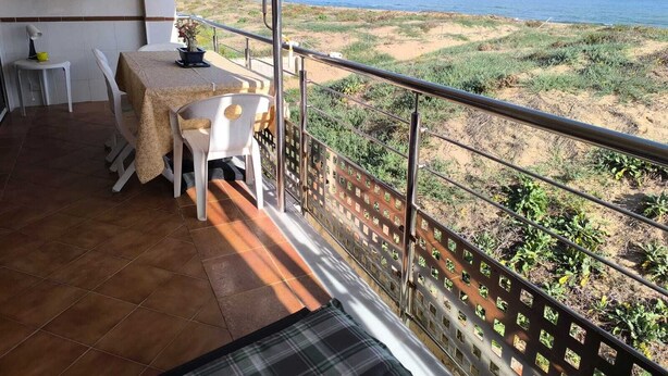 A balcony with a table and chairs, overlooking a beach with dunes and the sea. - Apartment/ flat - Playa de Xeraco - XERACO (Xeraco)
