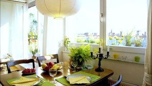 A dining table set with plates, cutlery, and a candle holder. - Over the roofs of Berlin with lift and a great view at the TV tower (Berlin)