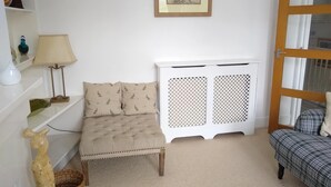 A room with a bed, a bedside table, a lamp, a decorative sculpture, a framed picture, and a window. - Beautiful 3 bedroom apartment in London (Tooting)