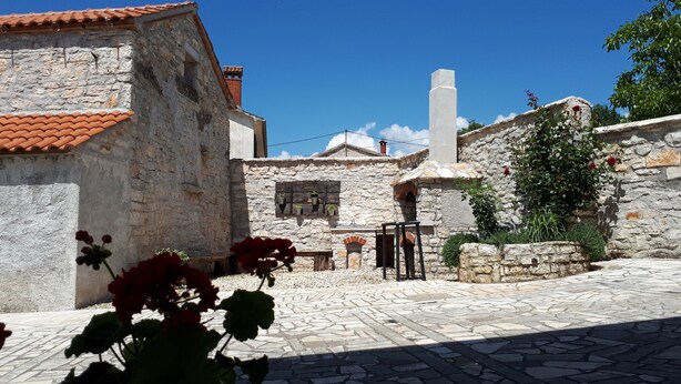 A stone building with a tiled roof, a chimney, and a stone wall with a window. - Vocation Home Ana In Kringa Istra, 8 Persons, 3bedrooms, 2 Bathrooms, with Pool (TINJAN)