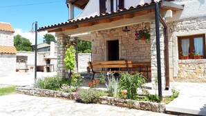 A stone building with a wooden bench and potted plants. - Vocation Home Ana In Kringa Istra, 8 Persons, 3bedrooms, 2 Bathrooms, with Pool (TINJAN)