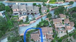 An aerial view of a residential area with multiple houses, a swimming pool, and a blue outlined area indicating a specific location. - Typical house of Provence in quiet surroundings, with breathtaking sea-view (Le Lavandou)