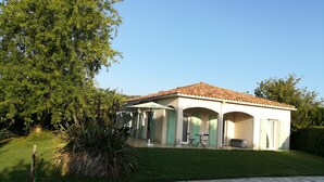 A house with a tiled roof, a swimming pool, and a well-maintained lawn. - Pleasant villa seaside with private pool garden 2000m2 (SOLARO)
