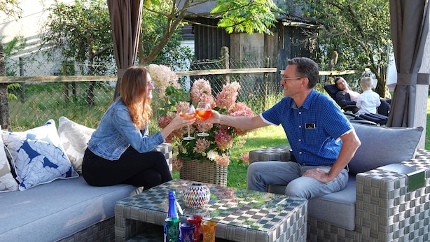 An outdoor seating area with wicker furniture and a checkered table. - 4 star holiday home "Zum Weiher" 160sqm in the heart of the Hunsrück-Hochwald National Park  (Allenbach)