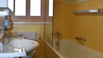 Bathtub, hair dryer, towels, soap