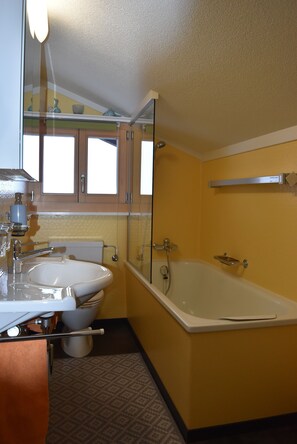 Bathtub, hair dryer, towels, soap
