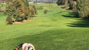 Een golfbaan met een bergachtig achtergrond.
