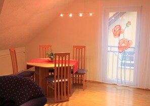 A dining area with a table set for four, a Christmas tree, and a window with a flower decoration. - 3-star vacation apartment on the Rheinsteig with a magnificent view over the Rhine Valley (Rüdesheim am Rhein)