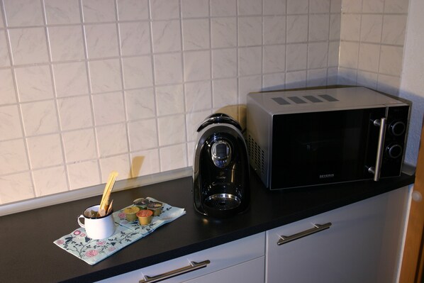 A kitchen with a coffee maker, toaster, and a cup with utensils on a countertop. - Detached holiday home, Apartment 2 / for 2-4 persons, W-LAn free (Mehren)