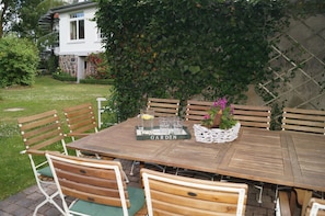 Enjoy al fresco dining in the garden, surrounded by lush greenery and a charming outdoor setting.