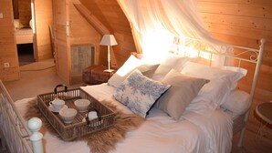 A cozy bedroom with a canopy bed, a bedside table with a lamp, and a wicker tray with cups and saucers. - Charming rooms with view  (La Roque-Gageac)