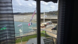 A balcony with a view of a marina, including boats and a waterfront restaurant. -  ENEZ BREHAT, Residence LE PORT, marina, Your balcony on the Port, (Perros-Guirec)