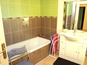 シャワー付き浴槽、ヘアドライヤー、タオル、トイレットペーパー