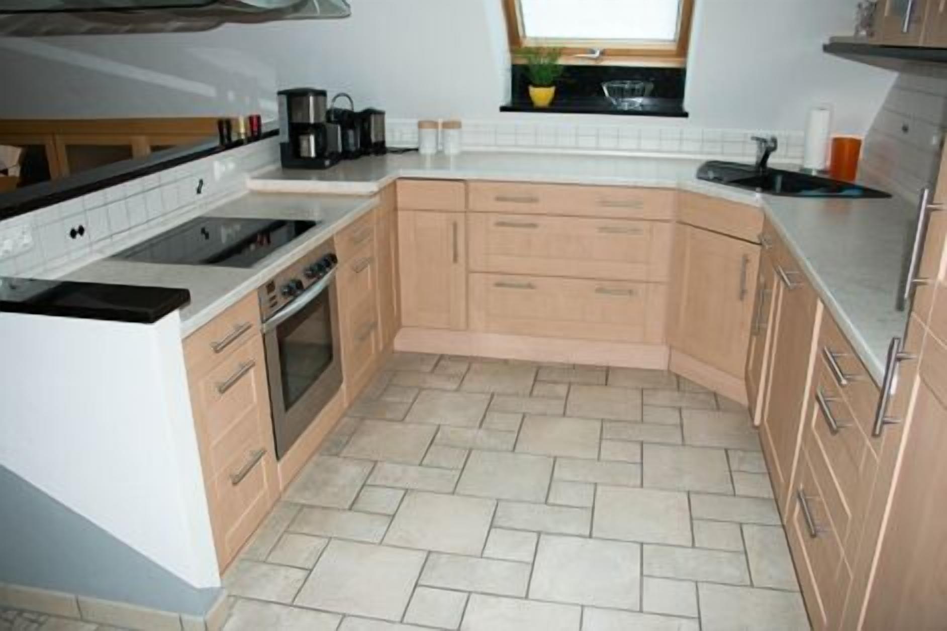 A kitchen with a stove, oven, and coffee maker.