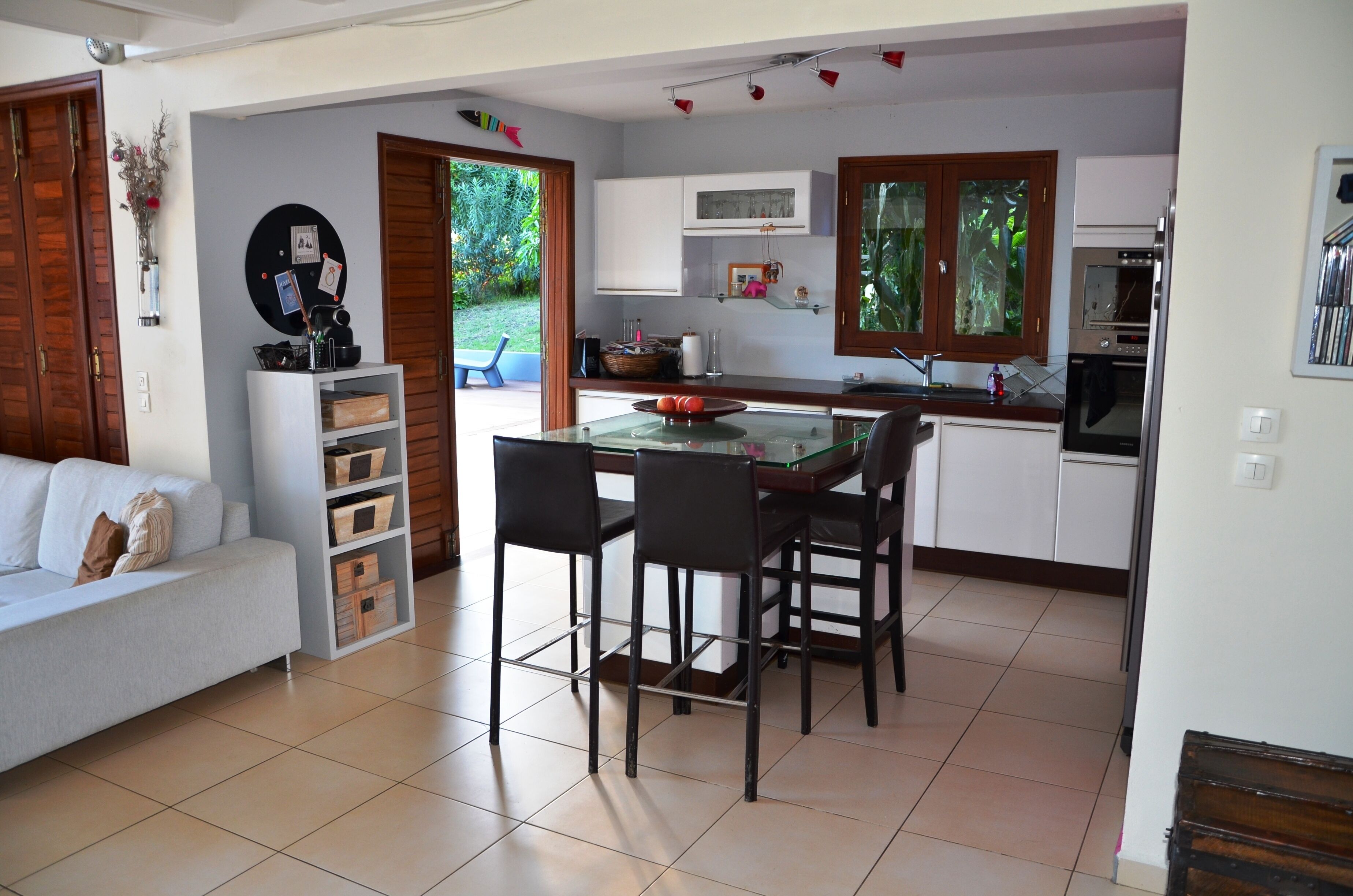 A compact kitchen with a dining area, white cabinets, and a small island.