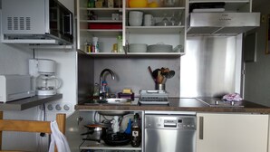 A compact kitchen with a microwave, coffee maker, sink, and a Bosch refrigerator. - Apartment facing south, magnificent views, secure private garage (Font-Romeu-Odeillo-Via)