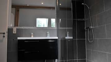 Bathtub, hair dryer, towels, toilet paper