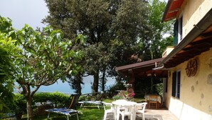 A patio with stone flooring, outdoor furniture, and a view of the sea. - Rustico in a panoramic position, terrace with sea view. (Pietrasanta)