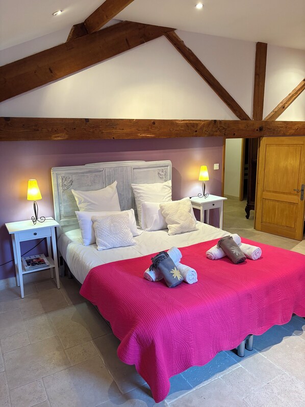 A bedroom with a bed, two bedside tables, a nightstand, and a wooden ceiling structure. - Charming house with heated swimming pool, in a quiet, unoverlooked location. (Saint-Rémy-De-Provence)