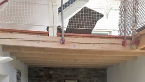 A modern living room with a stone fireplace, white sofas, and a wooden ceiling. - Quiet house, with open view and all the comfort in the heart of Alsace (Saint-Pierre-Bois)