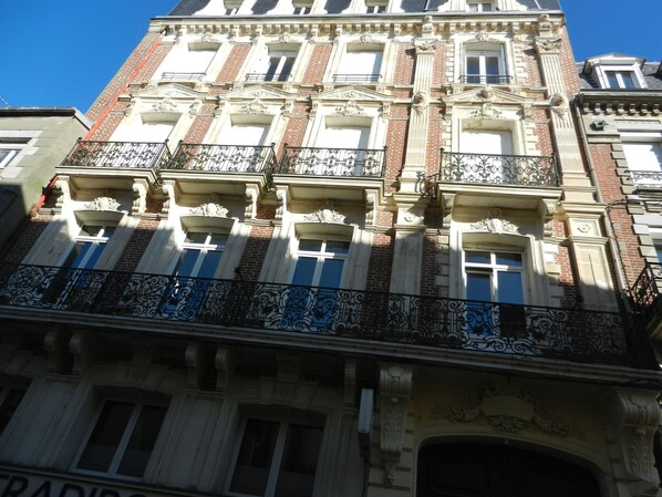 A multi-story building with ornate architectural details, including decorative balconies and a prominent entrance.