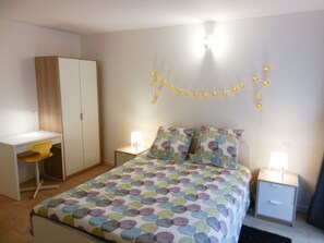 A bedroom with a bed, a desk, and a wardrobe. - 3 rooms hyper-center of Granville (Granville)
