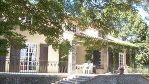 A stone building with a stone staircase leading to a covered porch. - Charming 70m2 villa with private pool (Castelnau D'auzan Labarrère)