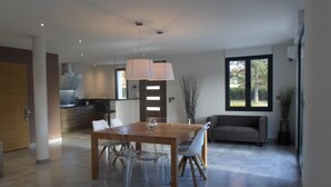 A modern kitchen with a wooden countertop and a built-in oven. - VILLA LES GRANGES- SWIMMING POOL surrounded by a green park overlooking the mountains  (Saint-Marcellin-Lès-Vaison)