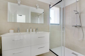 Shower, hair dryer, towels, toilet paper