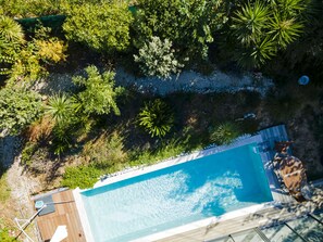 An aerial view of a swimming pool surrounded by lush greenery and a wooden deck. - SETE, listed villa 240 m2, 50 meters from the beach, 1st sea line, swimming pool (Sète)