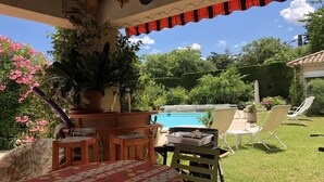 A patio area with a pool, outdoor furniture, and a variety of plants. - Large house in Sernhac (Sernhac)