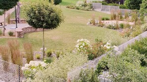 A landscaped garden with a stone wall, steps, and a variety of plants. - Terraced country house, 10 minutes from the slopes, at the foot of the mountains  (Breitenbach-Haut-Rhin)