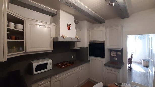 A kitchen with white cabinets, a microwave, and a gas stove. - APARTMENT 1ST FLOOR 4 ROOMS 2 BEDROOMS 2-4PERS (Colmar)