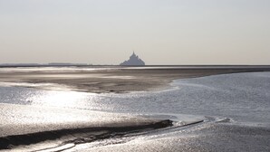 A beach with a distant island structure. - Charming cottage in peace between countryside and sea! With family, friends ......... (Sougéal)