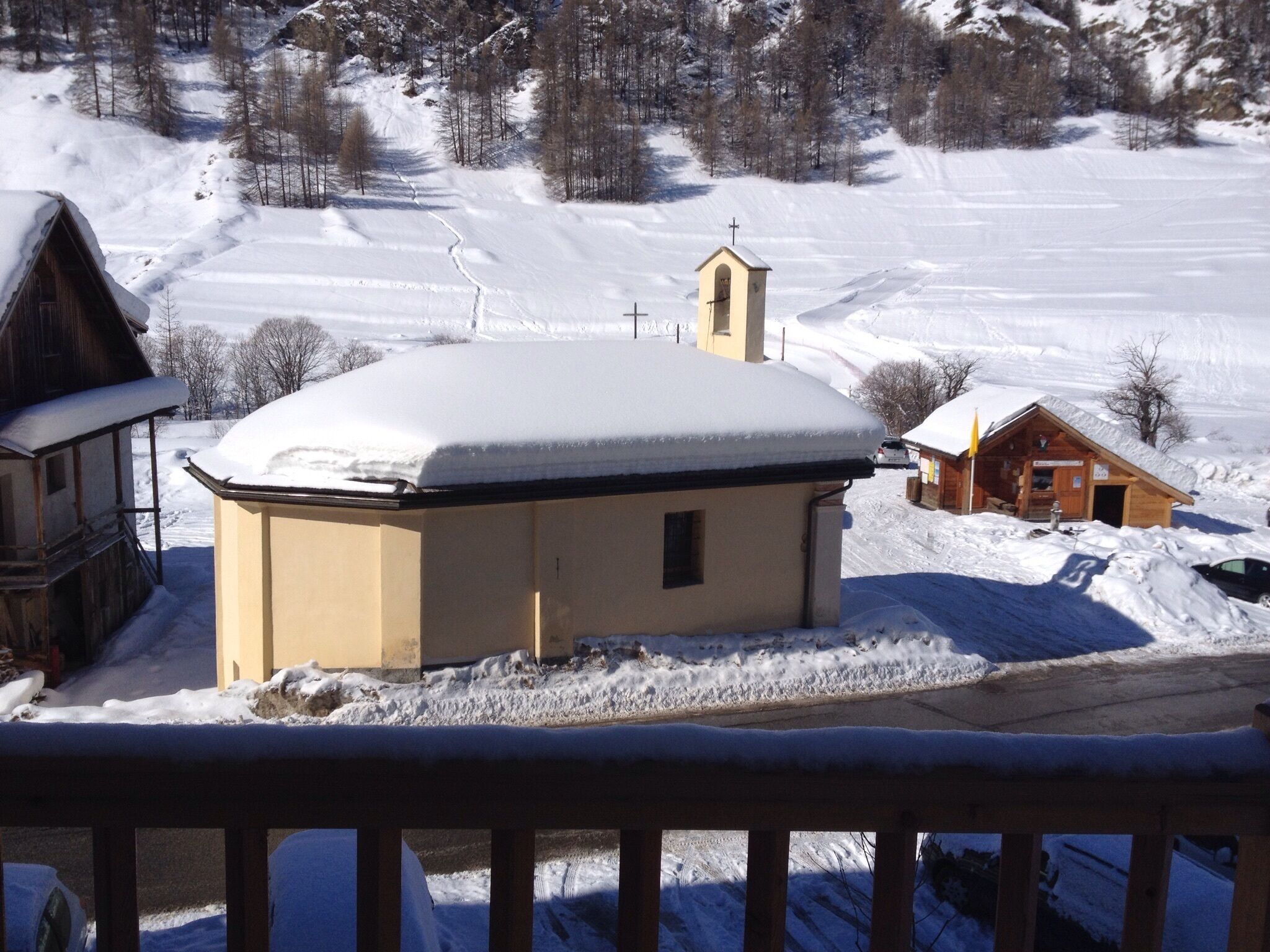 A snow-covered building with a small bell tower, surrounded by a snowy landscape.