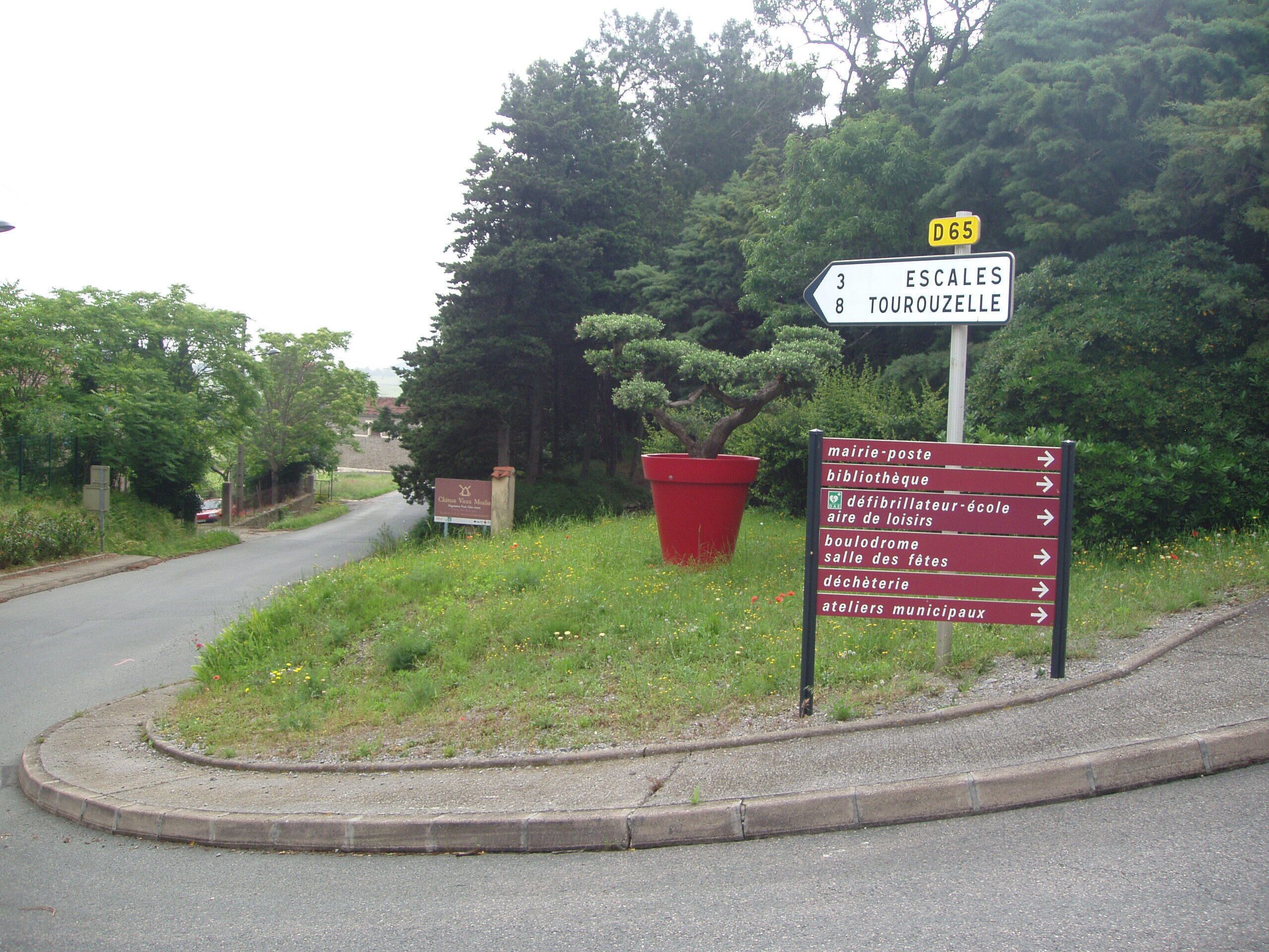 A directional sign with multiple arrows pointing to various local destinations.