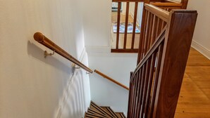 A wooden staircase with a handrail and a wooden railing. - old farmhouse renovated (Aiguillon)