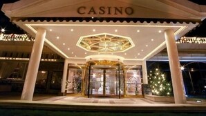 A casino entrance with a prominent 'CASINO' sign, a hexagonal ceiling design, and a glass door entrance. - SEASIDE VILLA / PETS ACCEPTED / WIFI / (Le Tréport)